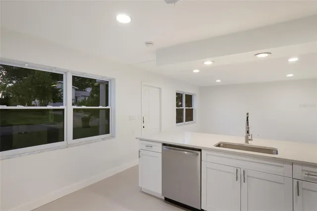 a kitchen with a sink and large window