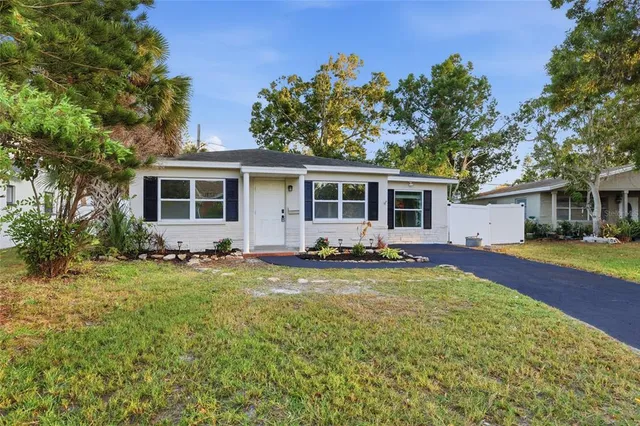 a view of a yard with a house and a swimming pool