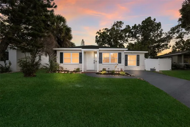 a front view of house with yard and green space