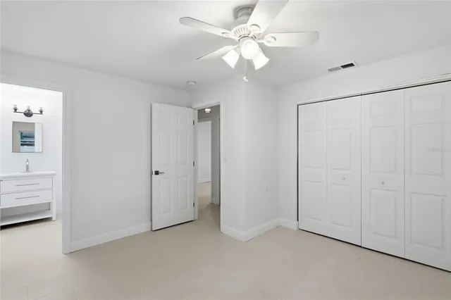 a view of an empty room with a ceiling fan