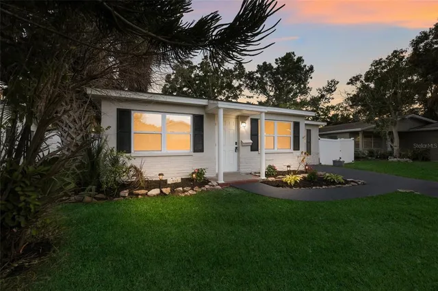 a front view of house with yard and outdoor seating