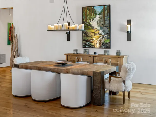 a dining room with a table chairs and a wooden floor