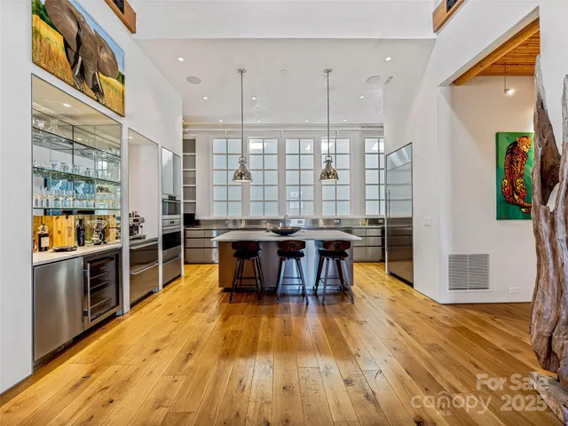 a view of a kitchen with dining room and wooden floor