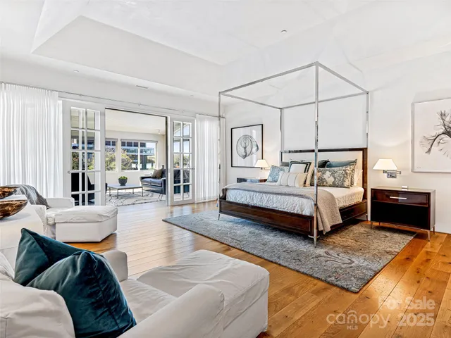 a spacious bedroom with a bed a couch and a window