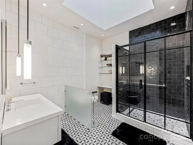 a bathroom with a shower toilet and sink