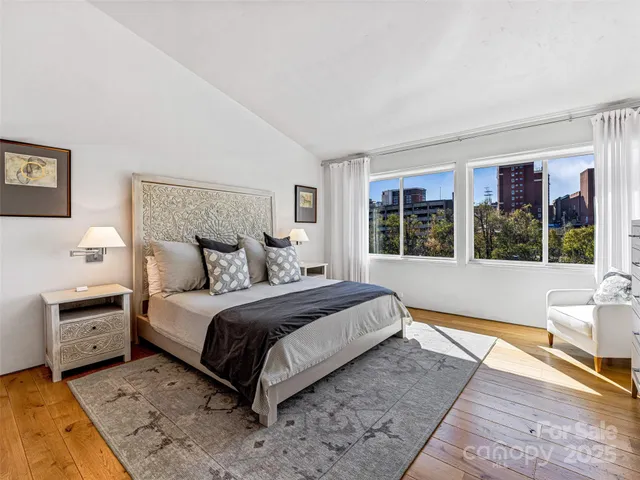 a spacious bedroom with a bed and a large window