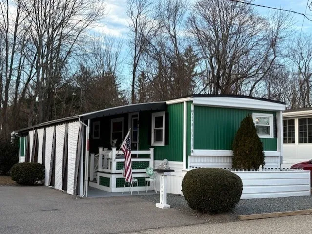 a view of a porch with furniture and a small yard