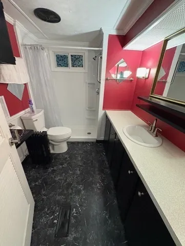 a bathroom with a sink toilet and mirror