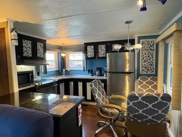 a kitchen with kitchen island a counter top space a sink and appliances