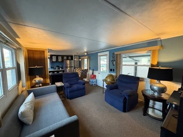 a living room with furniture and a lamp