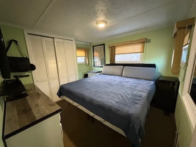 a bed sitting in a bedroom next to a window