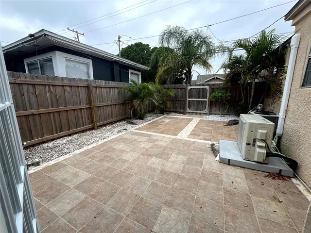 a view of backyard with small garden and outdoor seating