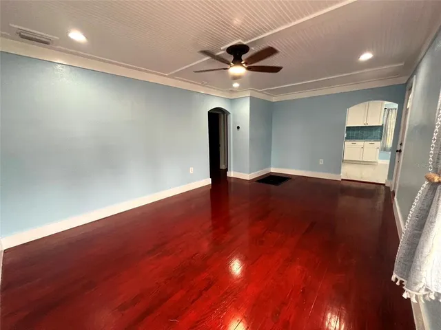 a view of a livingroom with a ceiling fan and wooden floor