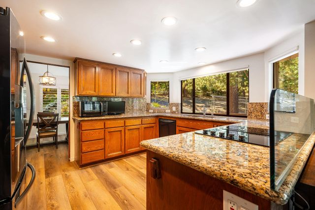 a kitchen with stainless steel appliances granite countertop sink stove and cabinets
