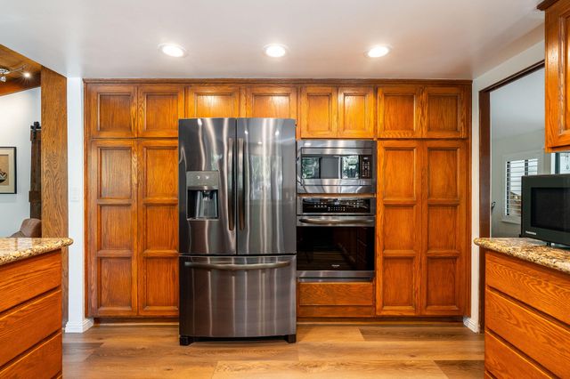 a view of a hallway with wooden floor and entryway