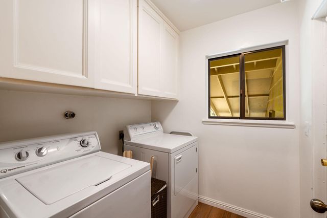 a bed sitting in a spacious bedroom next to a window
