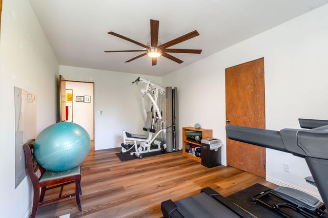 a view of a patio with table and chairs and wooden floor