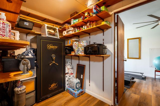 a view of a patio with table and chairs with wooden floor and fence