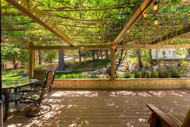 a view of a house with backyard sitting area and garden