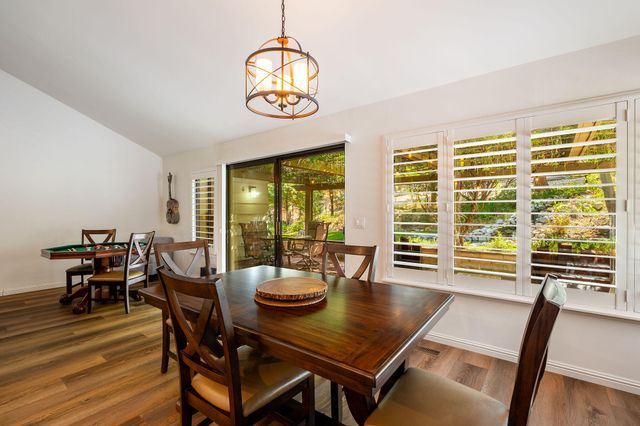 a large kitchen with stainless steel appliances granite countertop sink stove and large window