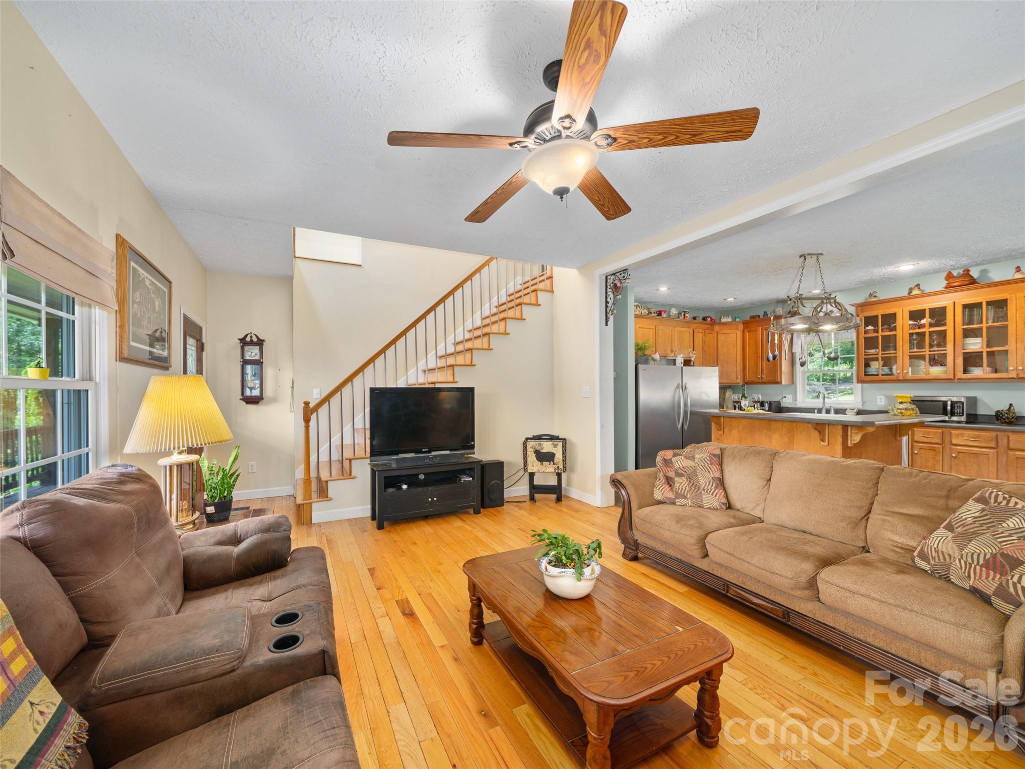 2216 Beans Creek Road Bakersville, NC 28705 - Photo 5 of 39 a living room with furniture and a flat screen tv