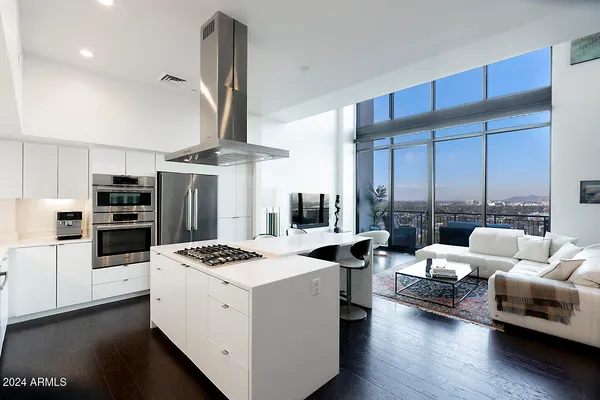 a living room with furniture and floor to ceiling window