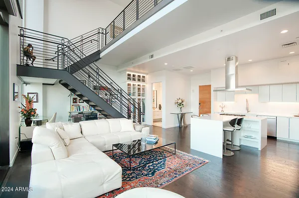 a living room with furniture and kitchen view