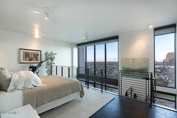 a bedroom with a large bed and a large window