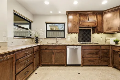a view of a dining room with furniture and a chandelier
