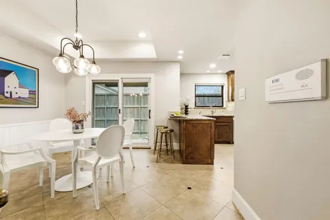 a spacious bedroom with a bed couch and large window