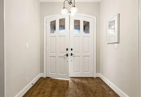a living room with fireplace furniture and a large window