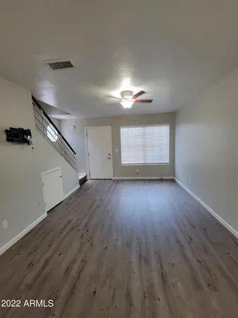a view of wooden floor and windows in an empty room