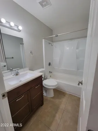 a bathroom with a double vanity sink toilet mirror and shower