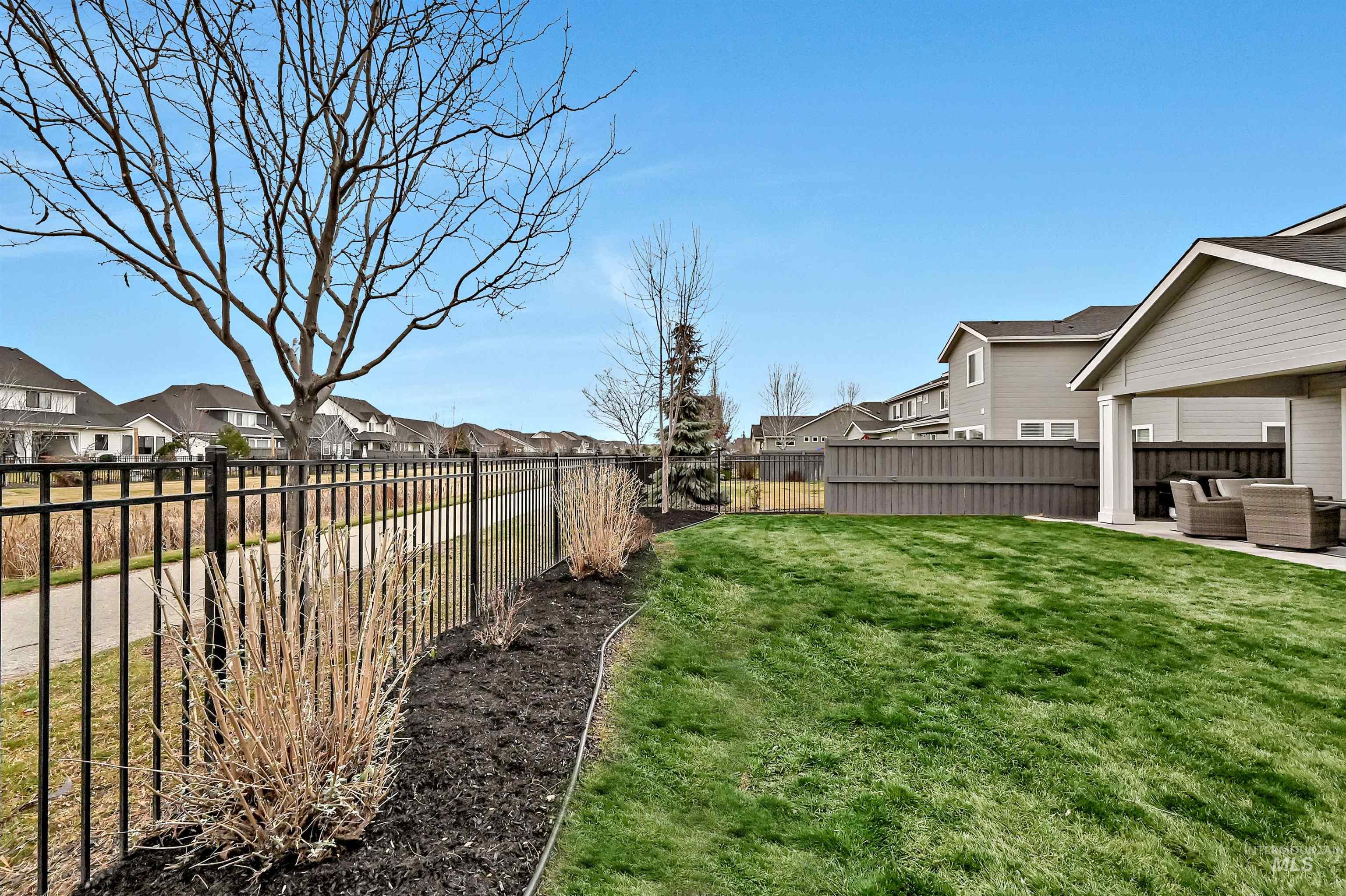 5802 South Wayland Way Meridian, ID 83642 - Photo 29 of 35 Fenced backyard featuring a residential view to the common area, an iron fence, a patio, and outdoor lounge area