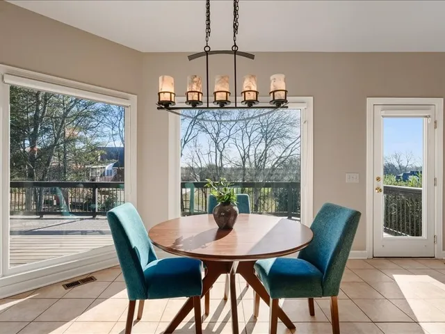 a view of balcony with wooden floor and fence