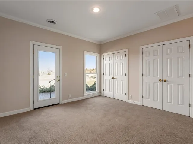 a view of kitchen with refrigerator and window