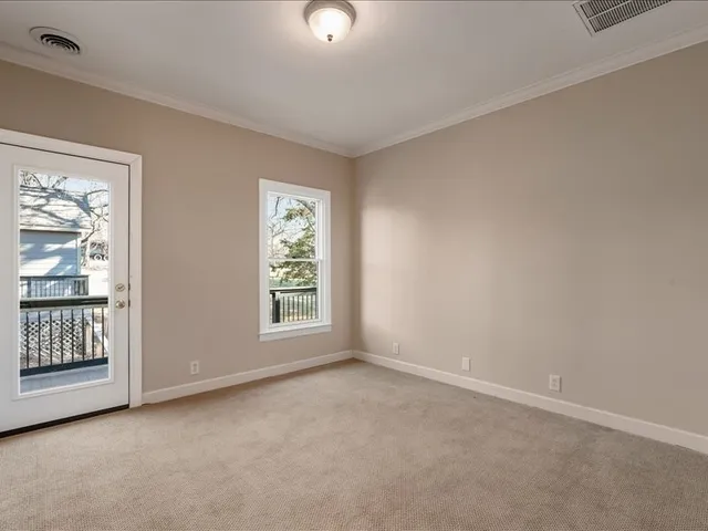 an empty room with windows and entrance