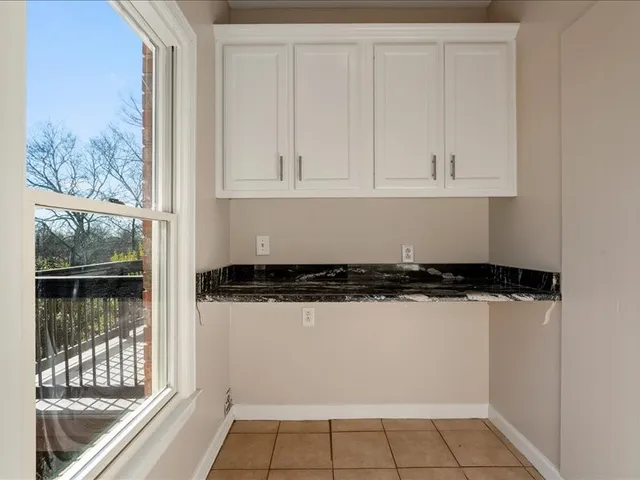 a view of a livingroom with a chandelier fan and wooden floor