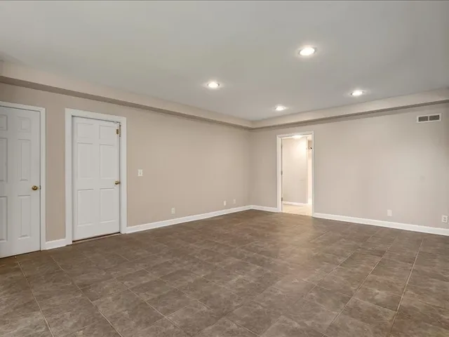 an aerial view of a house with garden space and a swimming pool