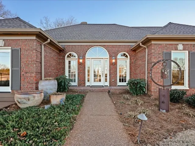 a front view of a house with garden