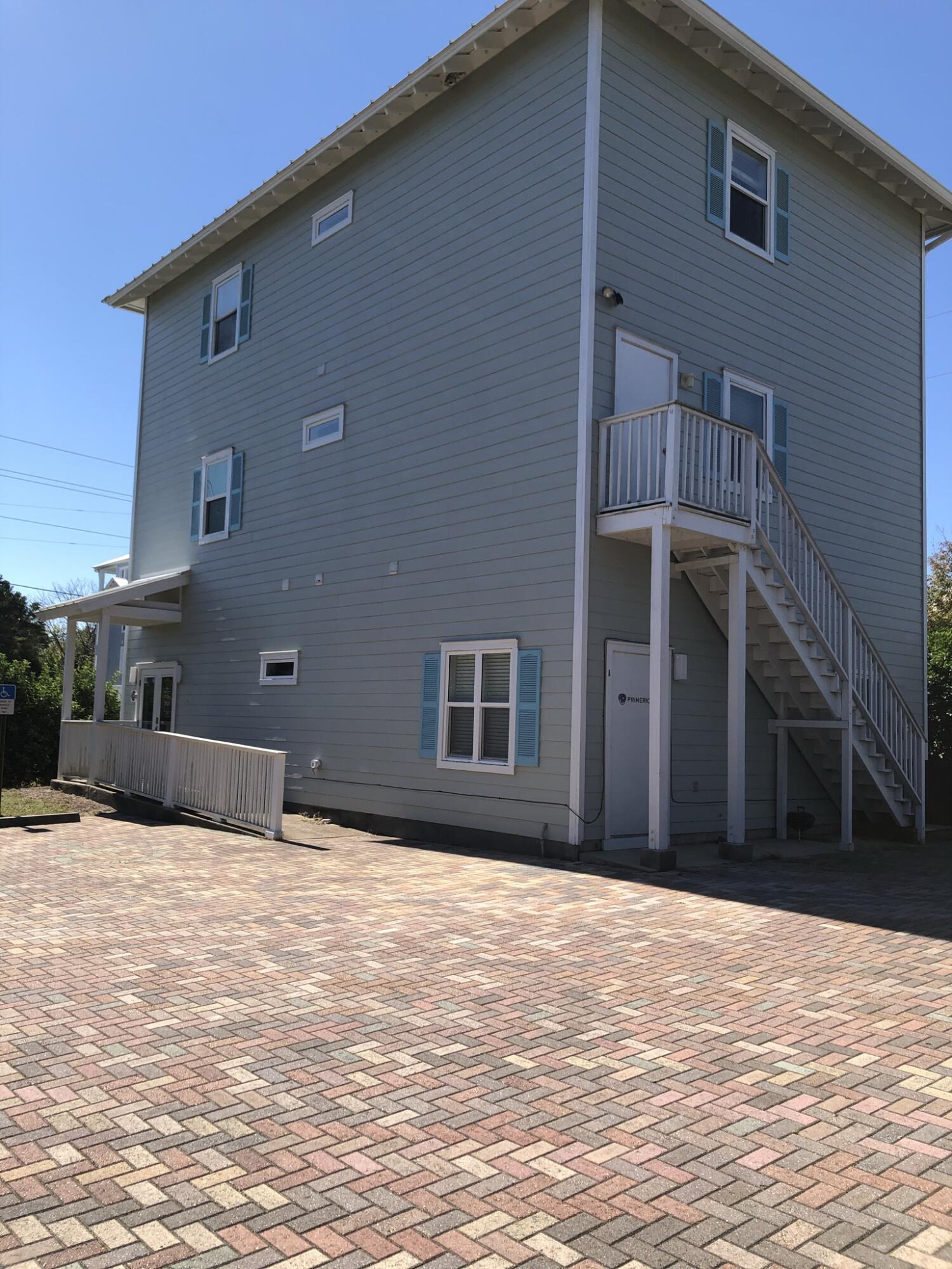 3754 West County Highway 30A, Unit 3 Santa Rosa Beach, FL 32459 - Photo 15 of 15 a view of a house with a yard