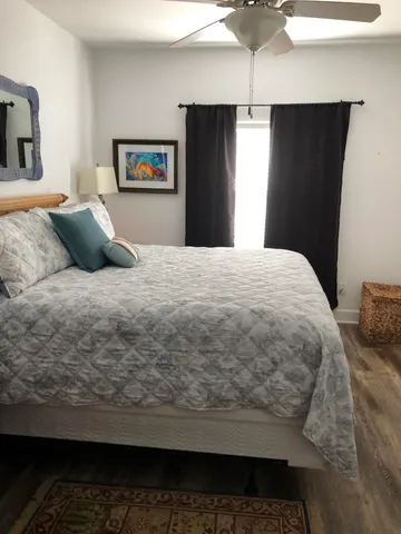 a bedroom with a bed and wooden floor