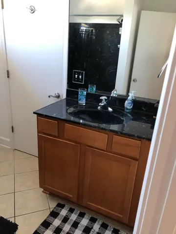 a bathroom with a sink a toilet and a mirror