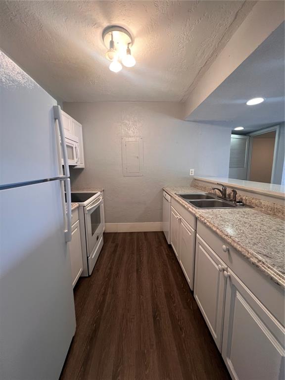 2266 Burnway Road, Unit 2266 Haines City, FL 33844 - Photo 8 of 13 a kitchen with a sink and refrigerator