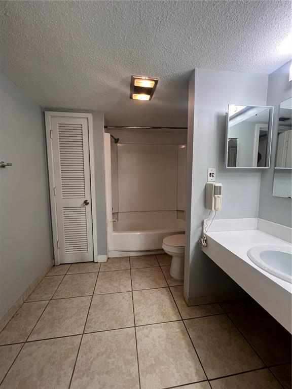 2266 Burnway Road, Unit 2266 Haines City, FL 33844 - Photo 9 of 13 a bathroom with a sink a toilet and mirror