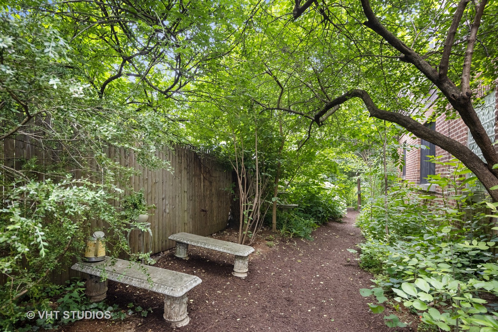 615 Riford Road Glen Ellyn, IL 60137 - Photo 29 of 33 a view of a backyard with lawn chairs plants and large tree