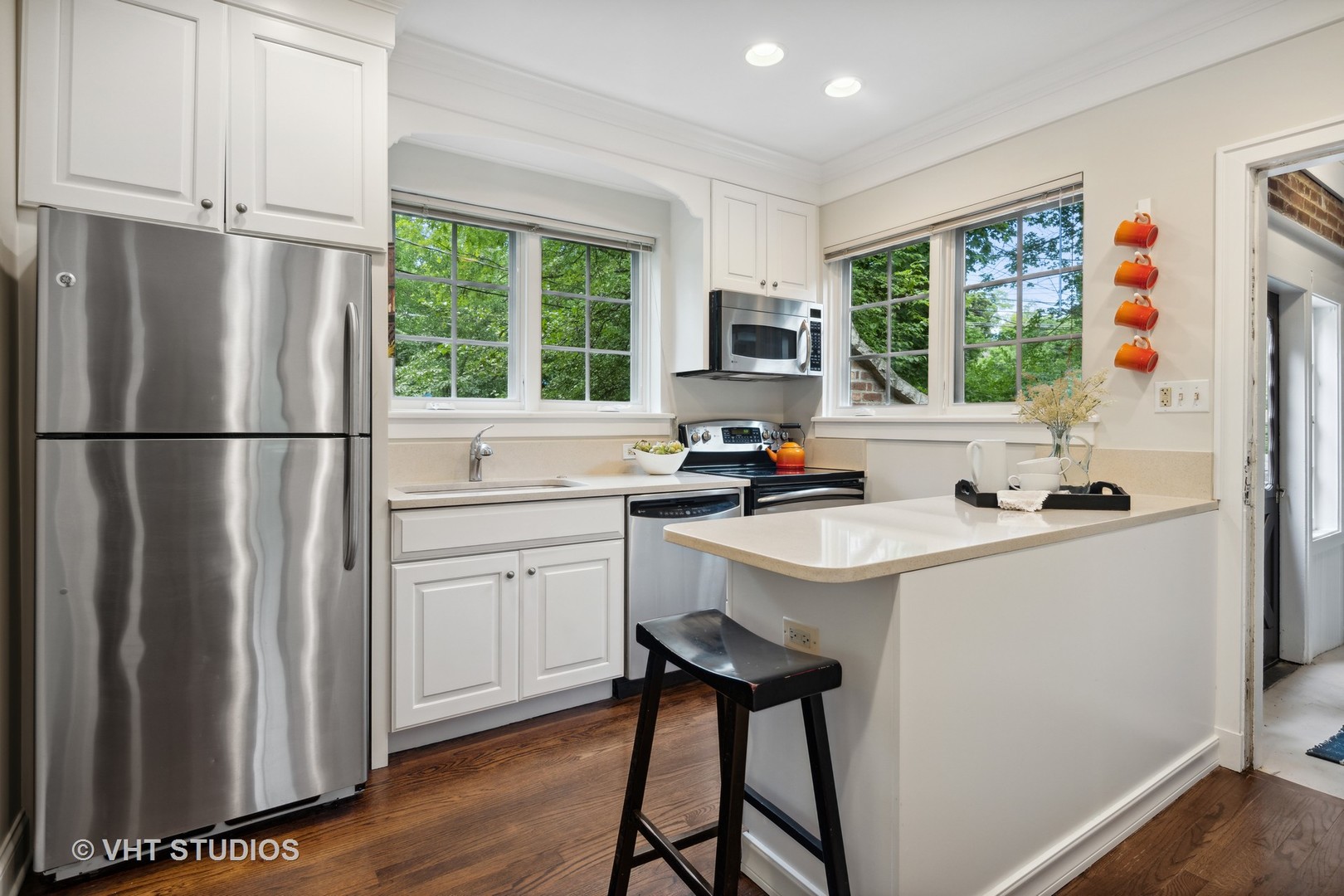 615 Riford Road Glen Ellyn, IL 60137 - Photo 10 of 33 a kitchen with a refrigerator a stove a sink dishwasher a stove and a refrigerator with wooden floor