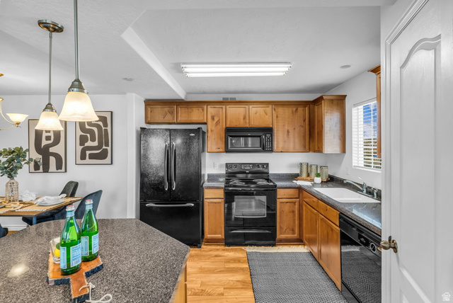 1136 West Spencer Road, Unit Y203 Pleasant Grove, UT 84062 - Photo 10 of 26 Kitchen with black appliances, decorative light fixtures, wood finish cabinetry, and light wood-style flooring