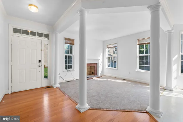 an empty space with wooden floor and windows