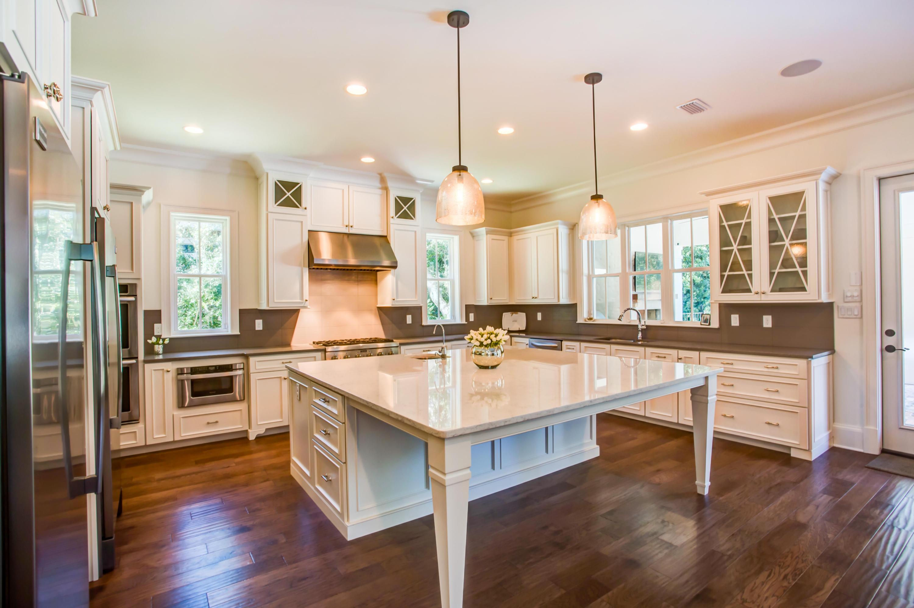 239 Mattie's Way Destin, FL 32541 - Photo 11 of 53 a large kitchen with kitchen island a large counter top space a sink stainless steel appliances and cabinets